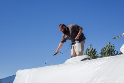 Applying Dicor Cool Coat to the roof of our travel trailer