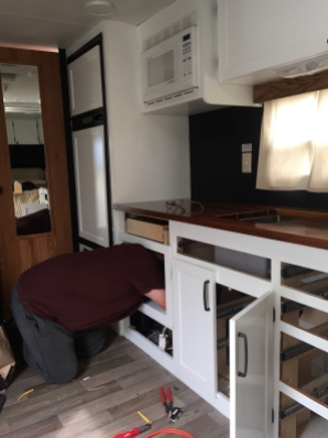 cabinet installation in travel trailer turned tiny house remodel